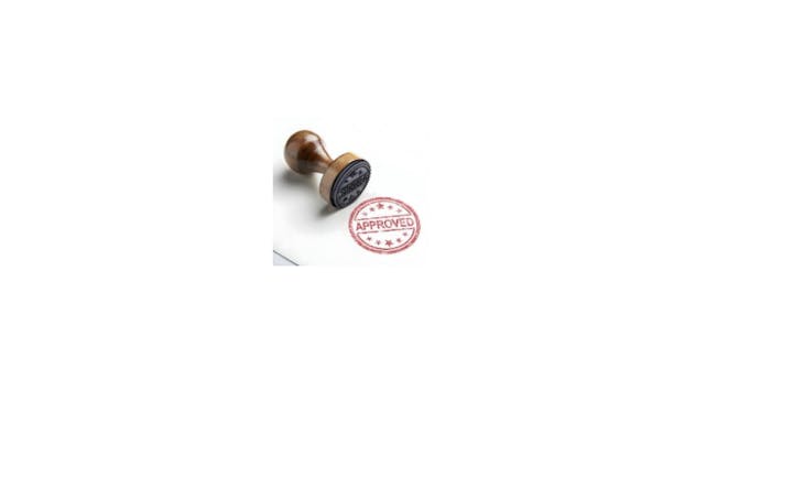 The image shows a wooden stamp with an "APPROVED" design beside it.