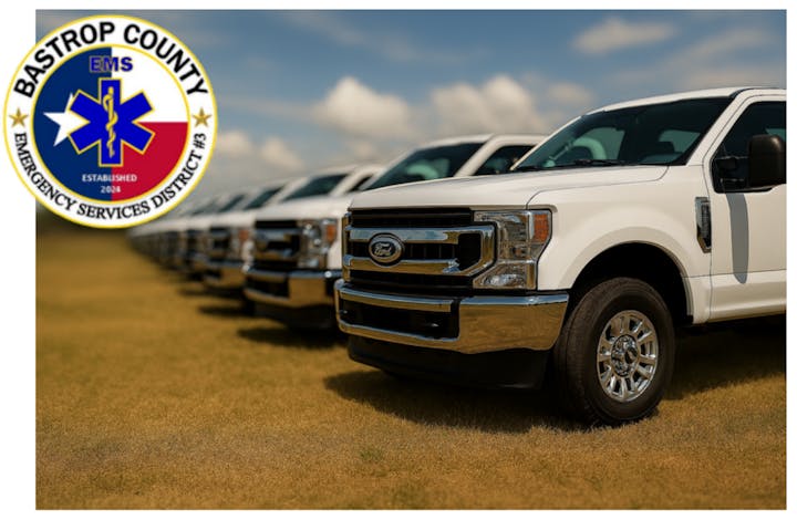 Line of white trucks on grass, badge overlay says "Bastrop County Emergency Services District #3" with EMS symbol.