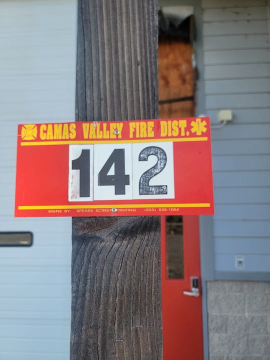 A sign reading "CAMAS VALLEY FIRE DIST. 142" is attached to a wooden post.