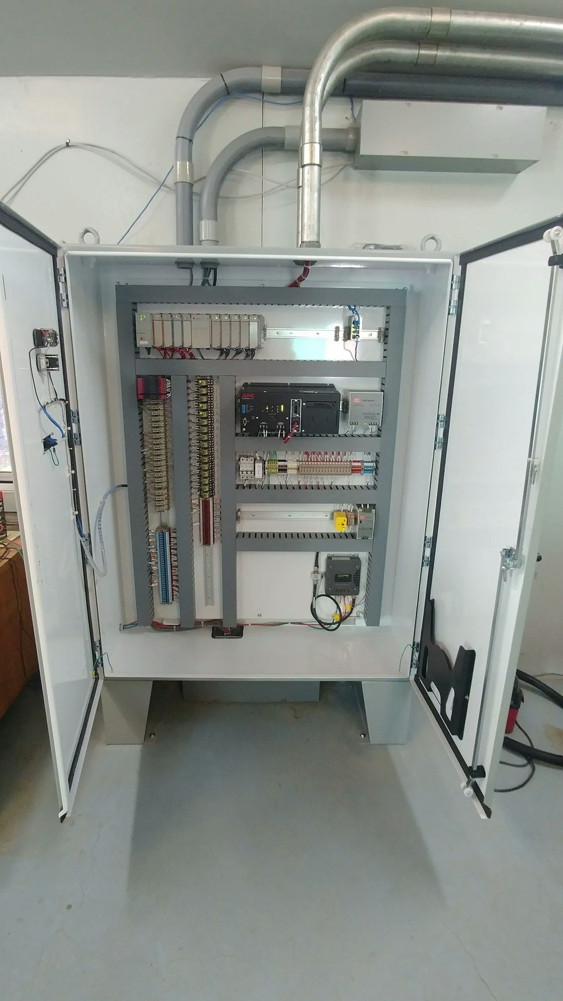 An open electrical panel with switches, wires, and components, likely for power distribution or control.