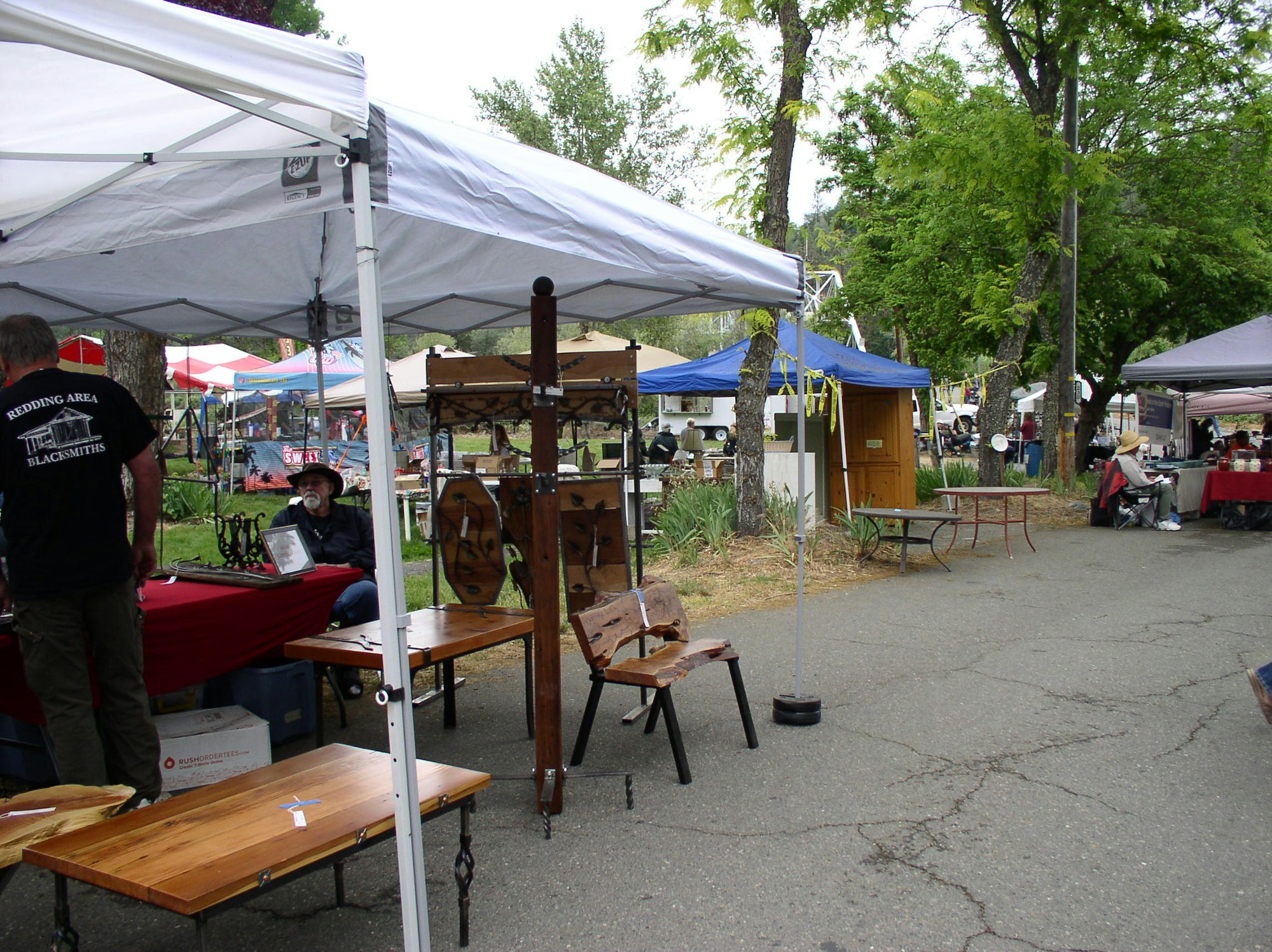 May contain: person, human, wood, tent, plywood, restaurant, tabletop, furniture, and chair