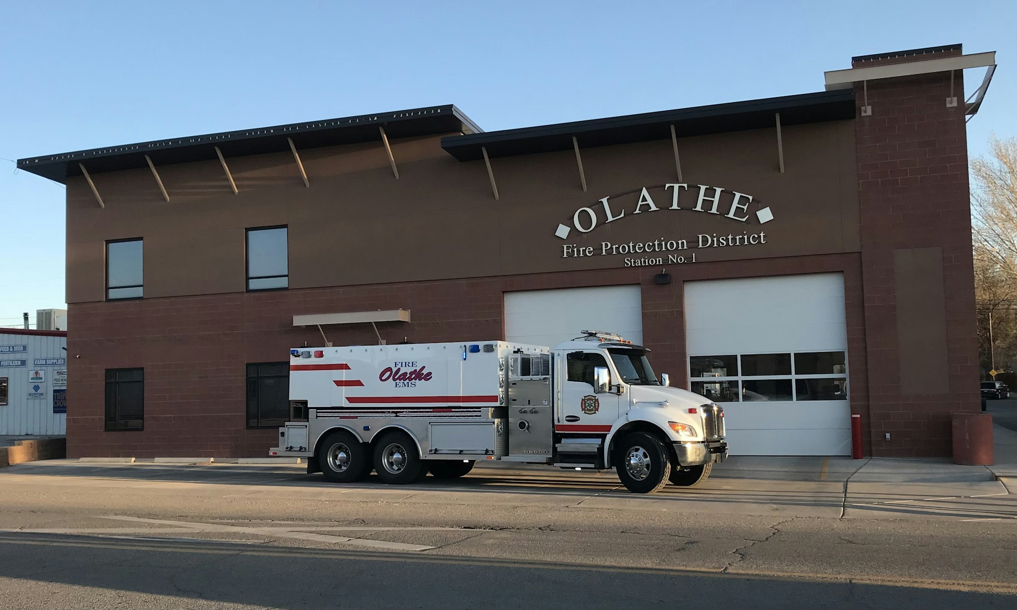 A fire station with a fire truck parked in front.