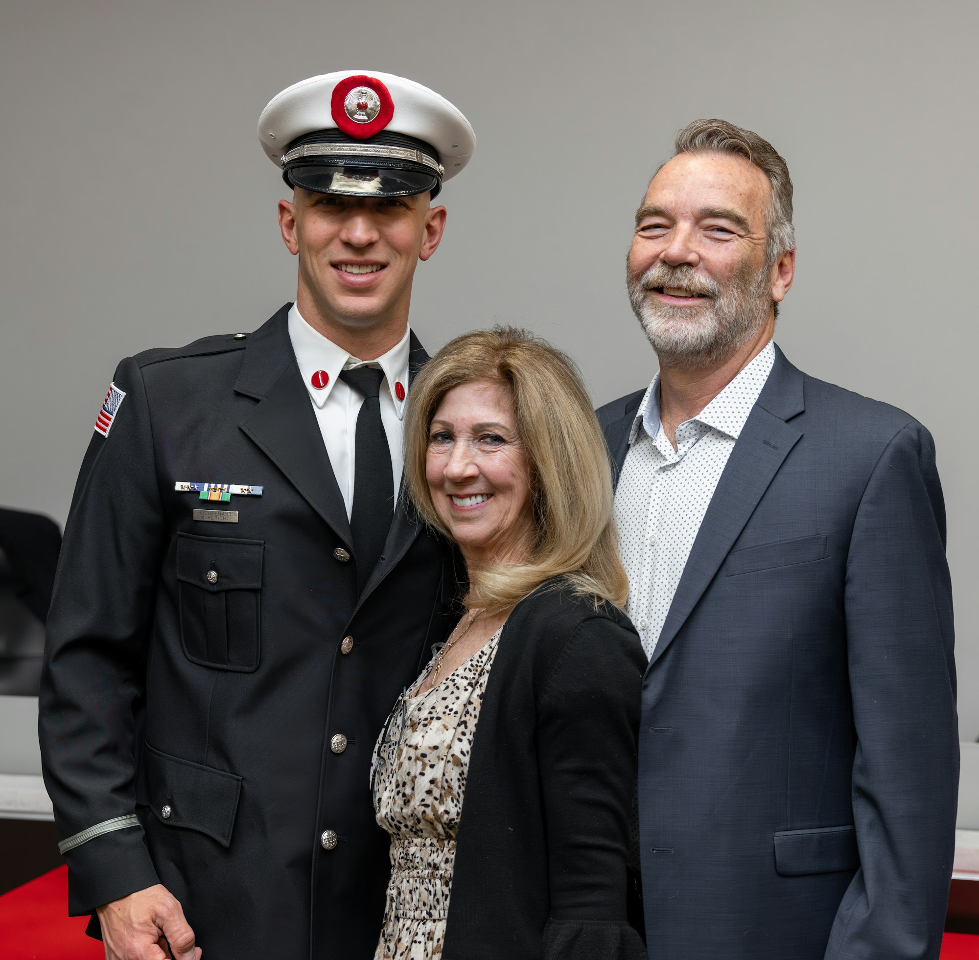 May contain: adult, female, person, woman, clothing, hat, male, man, fashion, accessories, formal wear, tie, officer, captain, and people