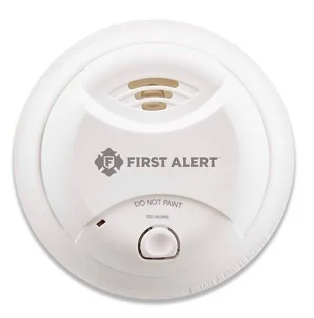 A white smoke detector with a "First Alert" logo.