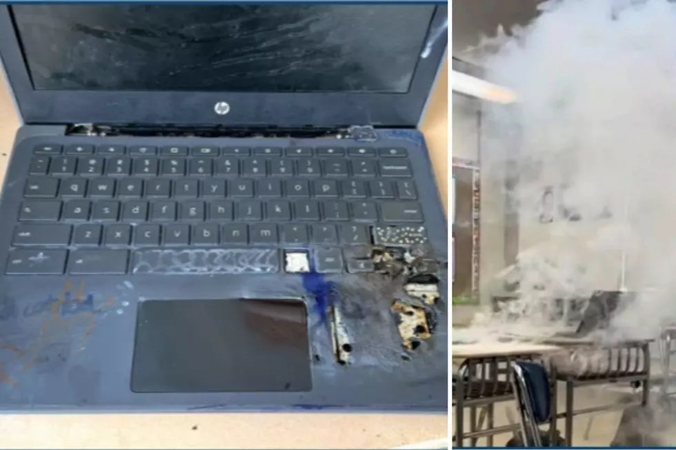A burned laptop with damage on the keyboard and a room filled with smoke.