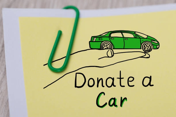 A note with a green paperclip and the message "Donate a Car," featuring a drawing of a car.
