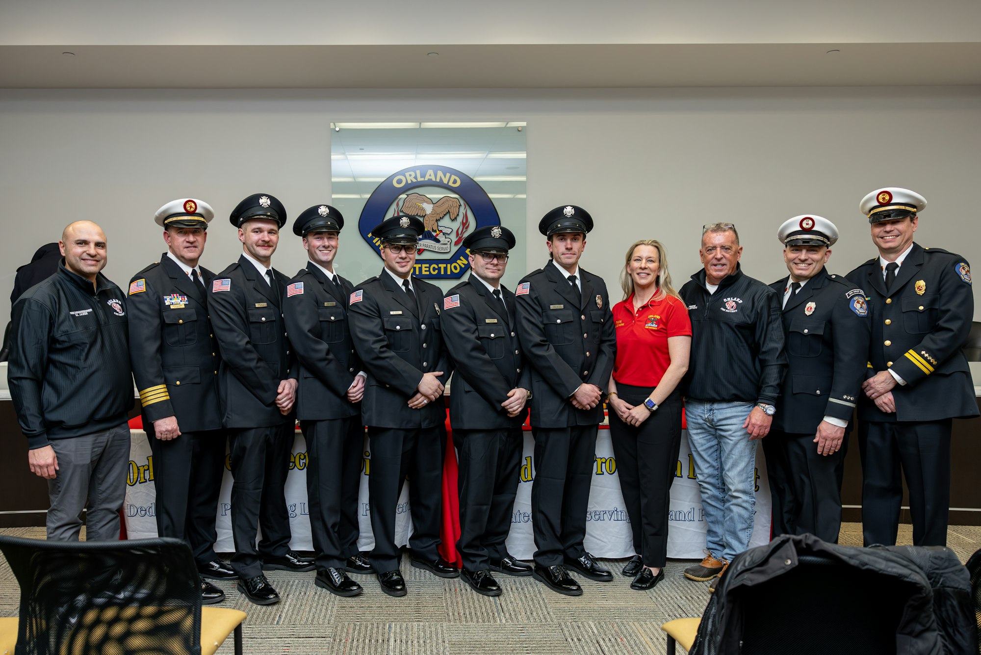 A group photo of uniformed officials, including firefighters and officers, posing together at an event in Orlando.