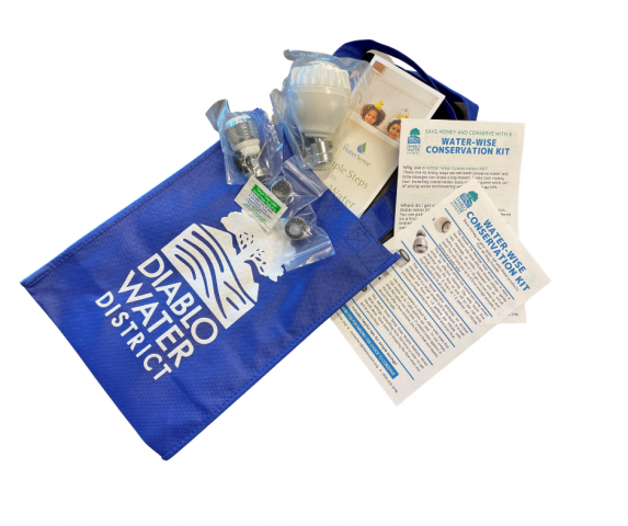 A blue tote with "Diablo Water District," containing water conservation items and flyers.
