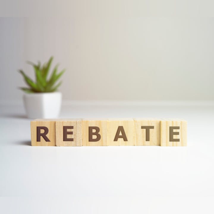 Blocks spelling "REBATE" with a plant in the background.