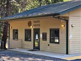 A small building labeled 'YOUTH CENTER' with windows, a door, and a ramp access.