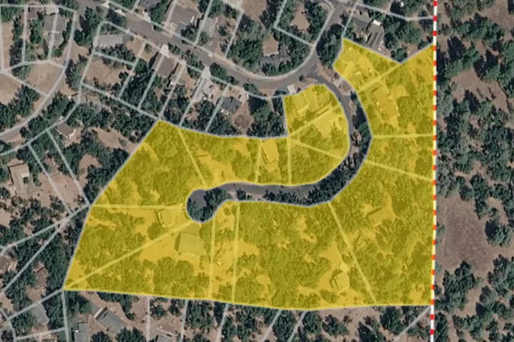 The image shows a map with highlighted yellow areas, indicating specific land features or zones among residential neighborhoods.