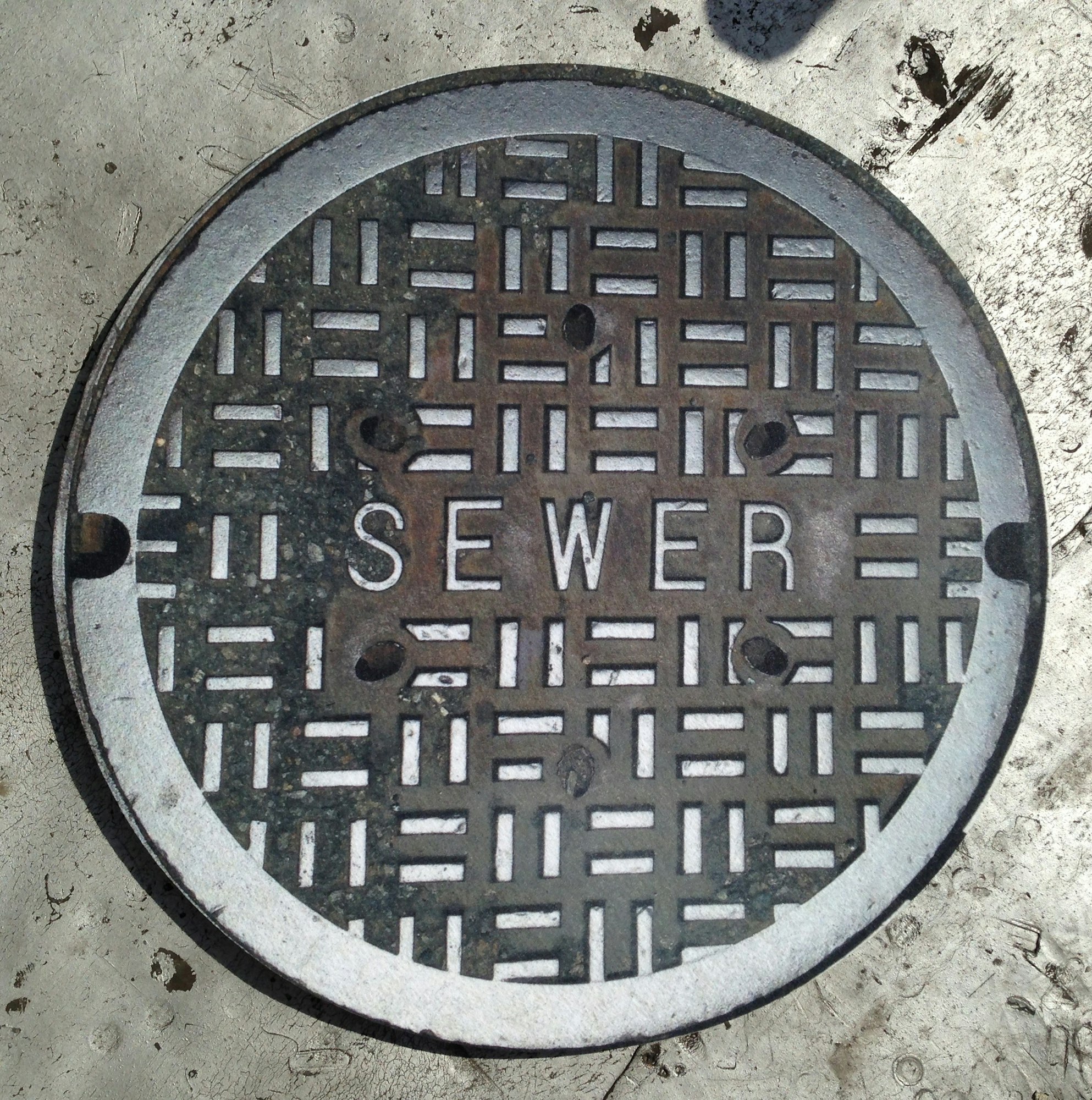 May contain: sewer, hole, manhole, drain, and rug