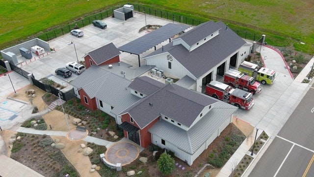 Aerial view of a fire station with fire trucks.