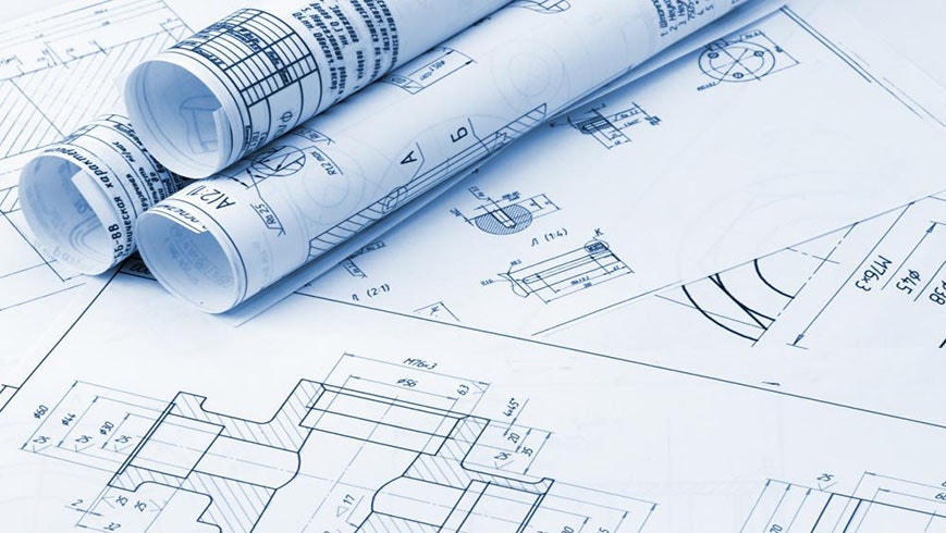 Rolled and flat architectural blueprints with technical drawings and schematics.