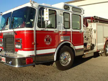 Red firetruck parked outdoors.