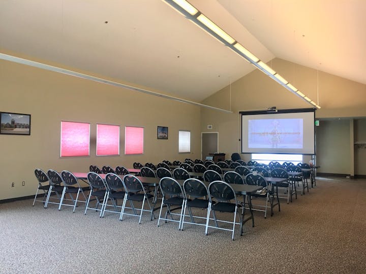 May contain: people, person, architecture, building, school, classroom, indoors, room, crowd, audience, lecture, hall, lecture hall, chair, furniture, art, and painting