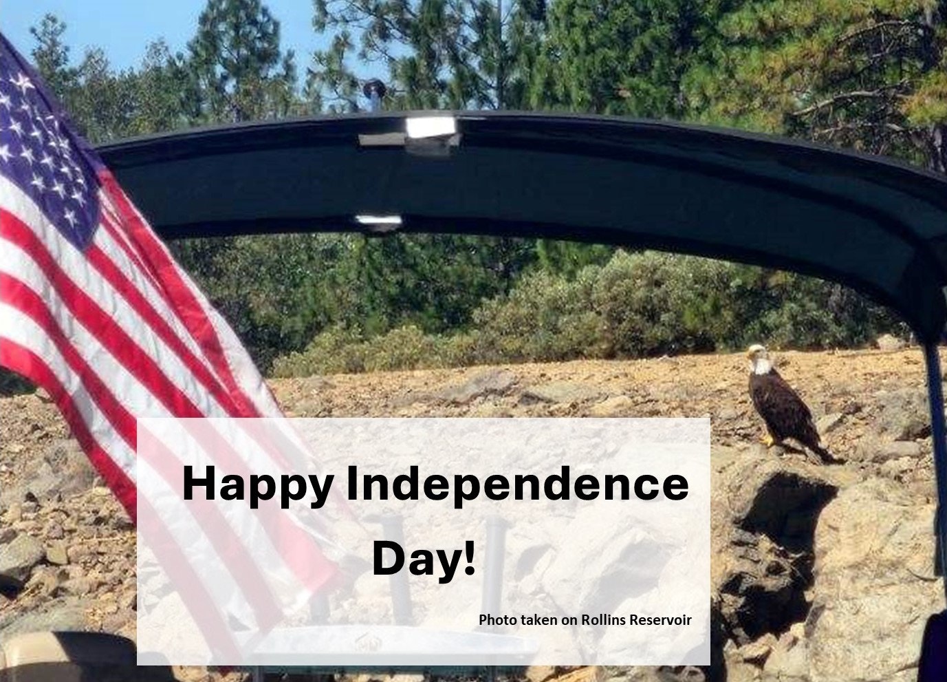 US flag, eagle, "Happy Independence Day!" text, outdoors at Rollins Reservoir.