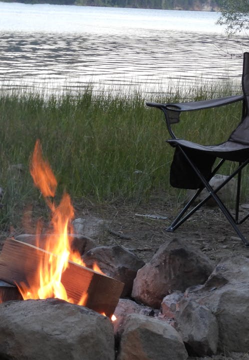 May contain: fire, flame, nature, outdoors, scenery, chair, furniture, and bonfire