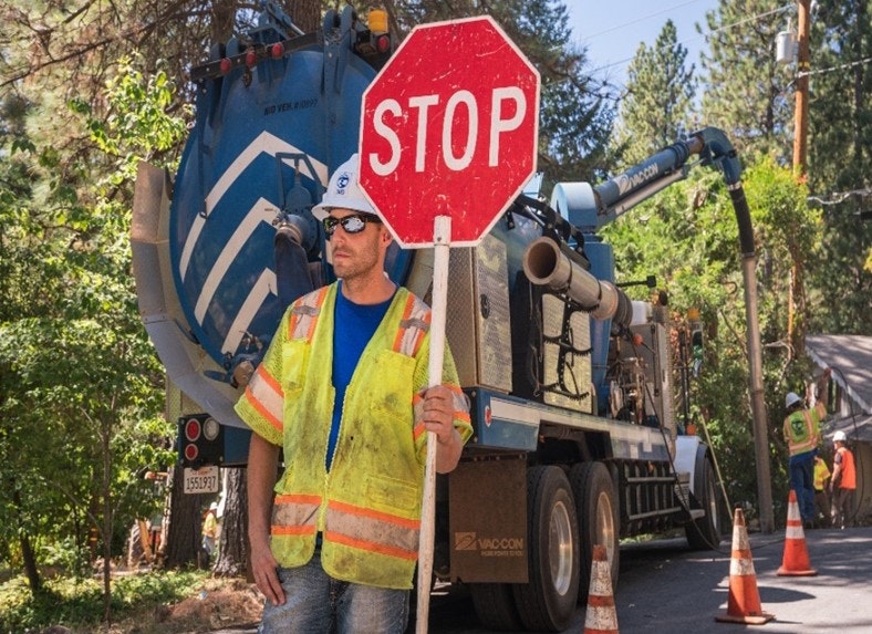 Maintenance Worker with a stop sign