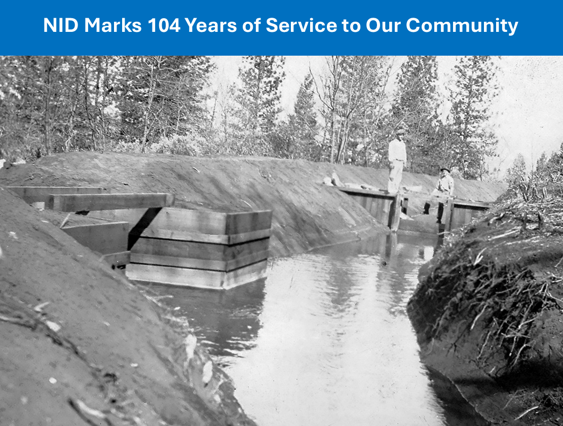 A historical irrigation channel with two people working, surrounded by trees. Text: "NID Marks 104 Years of Service to Our Community."