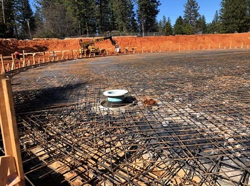 construction, rebar, tank site, trees, sky, equipment