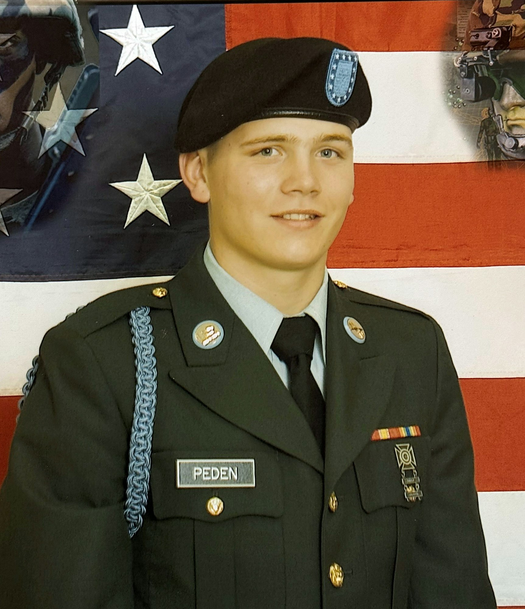 Person in a military uniform with a U.S. flag backdrop.