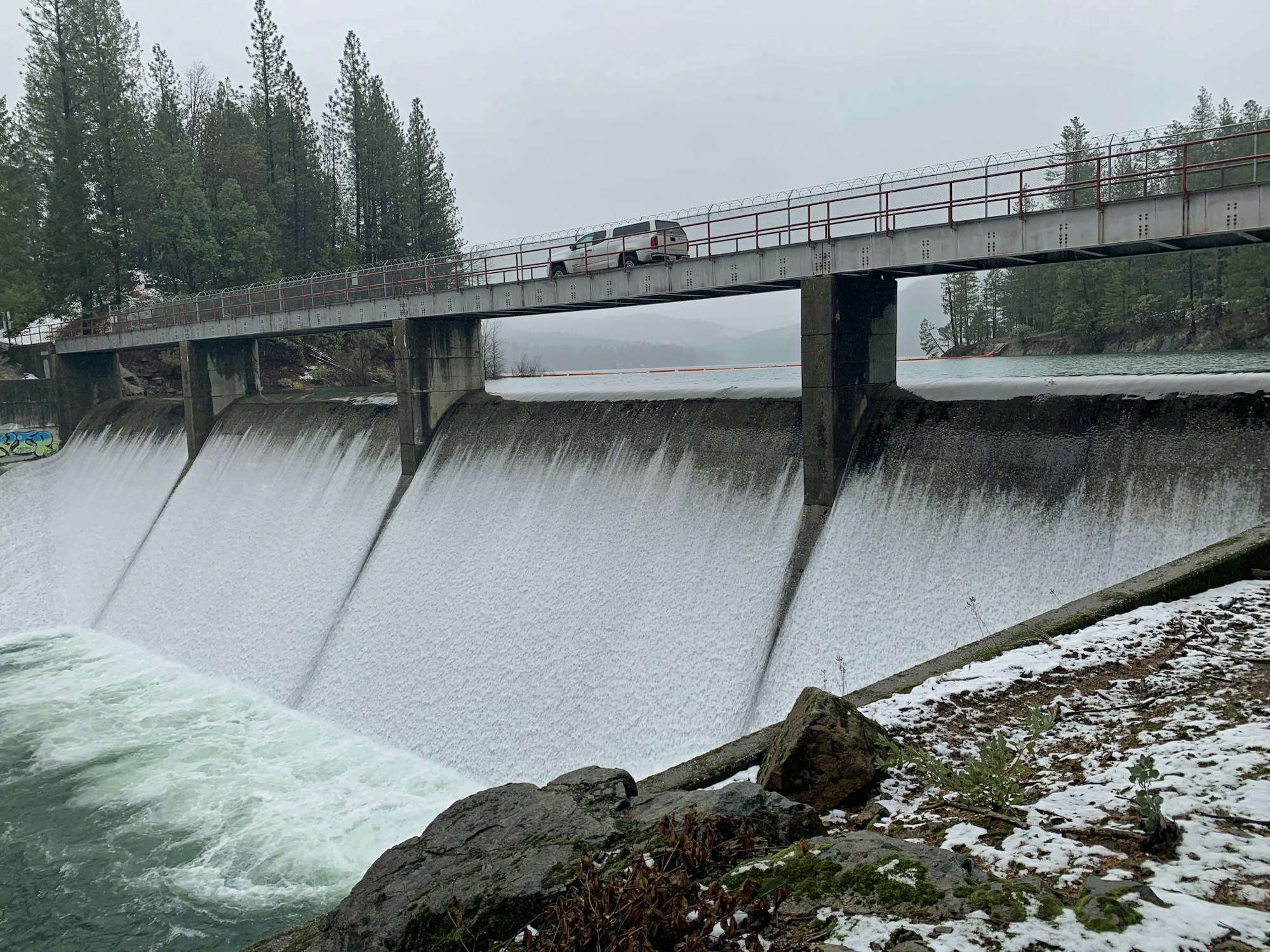 May contain: water, outdoors, bridge, car, vehicle, and transportation