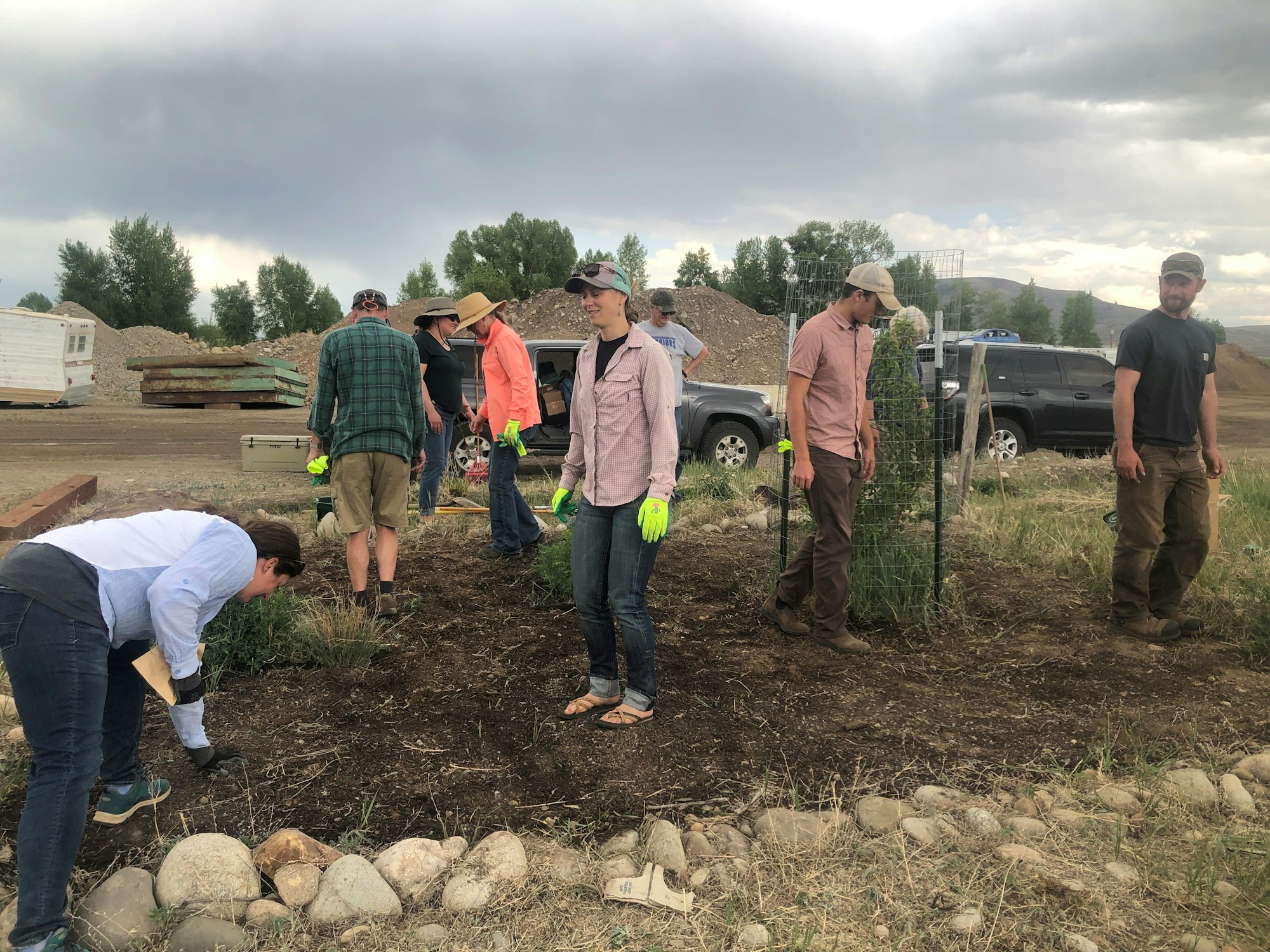 2022 Water Wise Pollinator Gardening Workshop Participants tamp down seed after preparing the bed