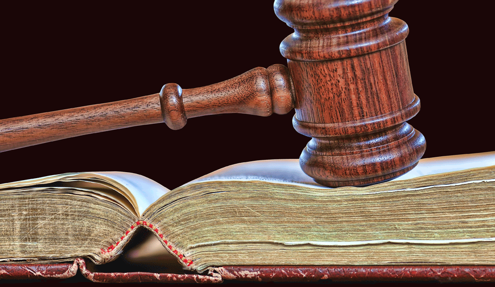 A judge's gavel resting on an open book.