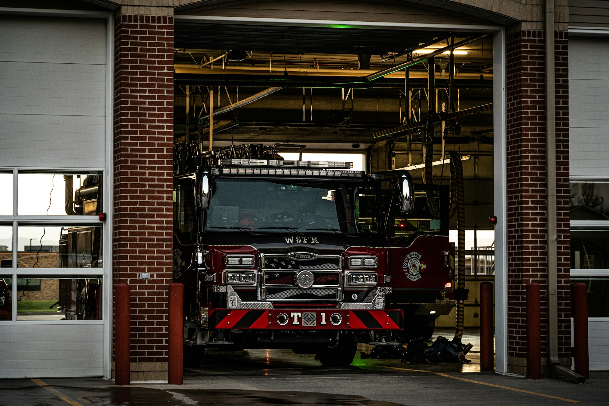 A fire truck parked inside a fire station garage.