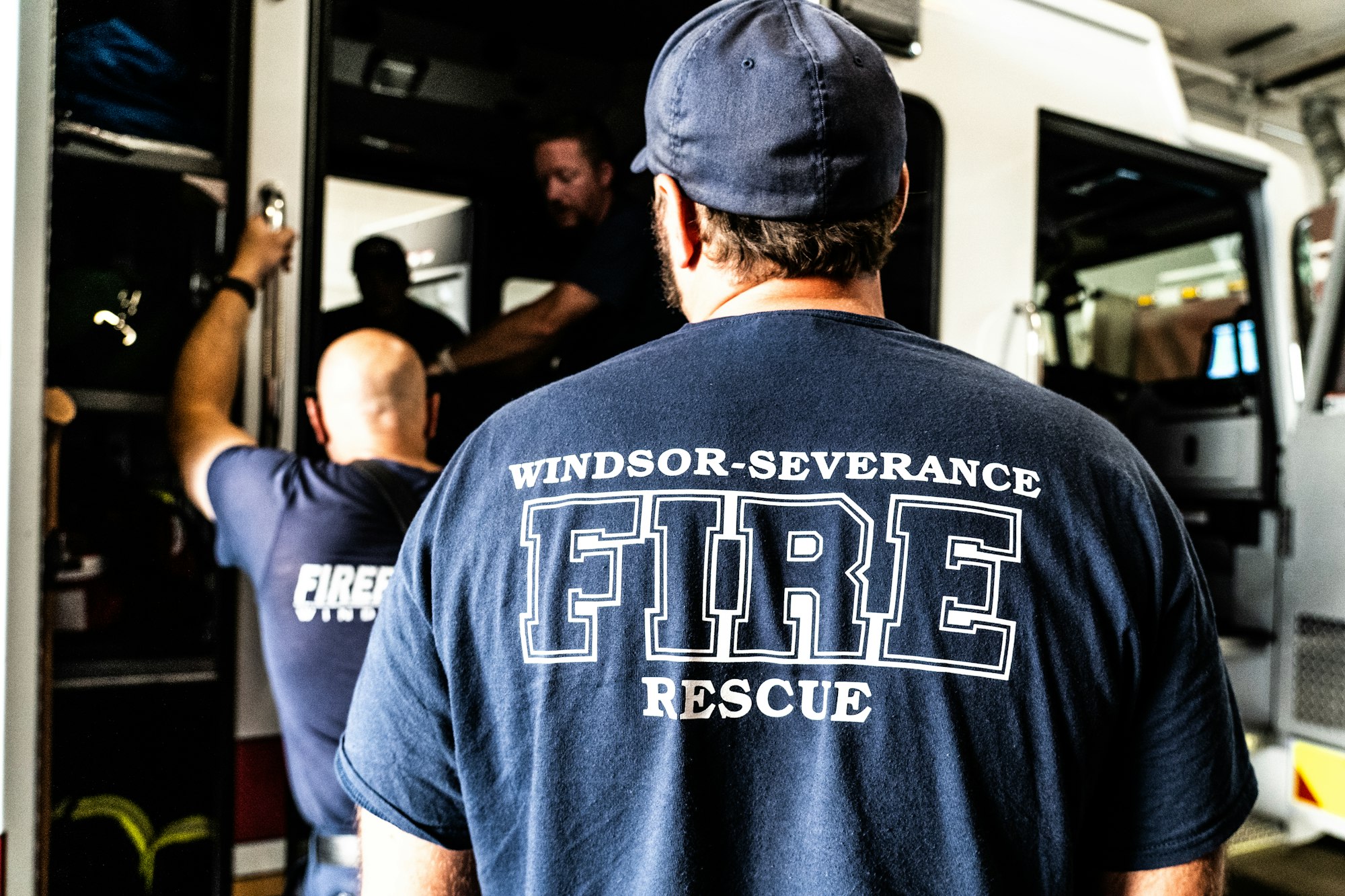 Firefighters from Windsor-Severance Fire Rescue near an ambulance.