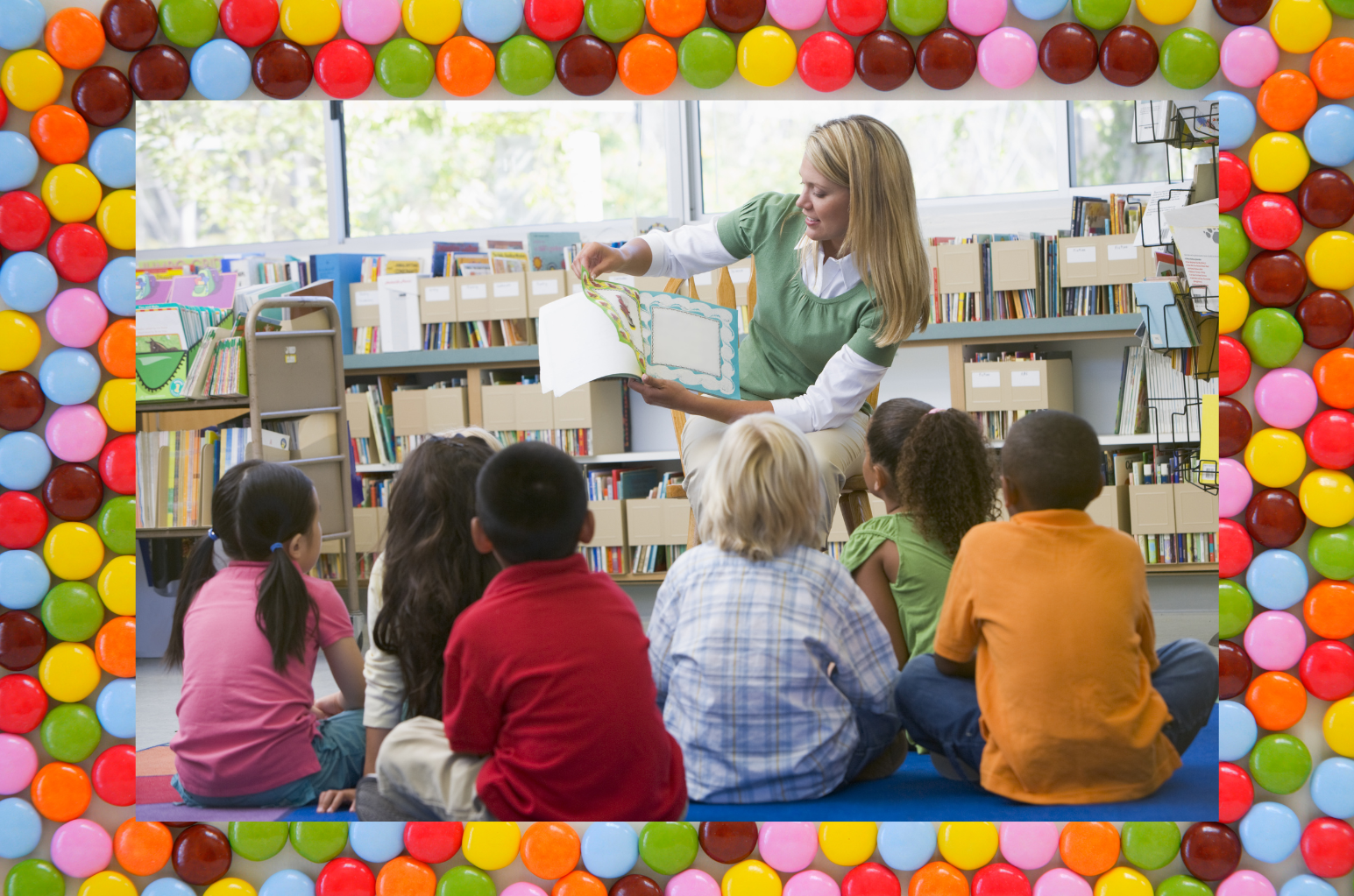 A woman reads to a group of children in a library, with colorful candy-like border framing the scene.