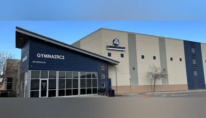 A building with "GYMNASTICS" on the facade and "CABOON VALLEY" logo.