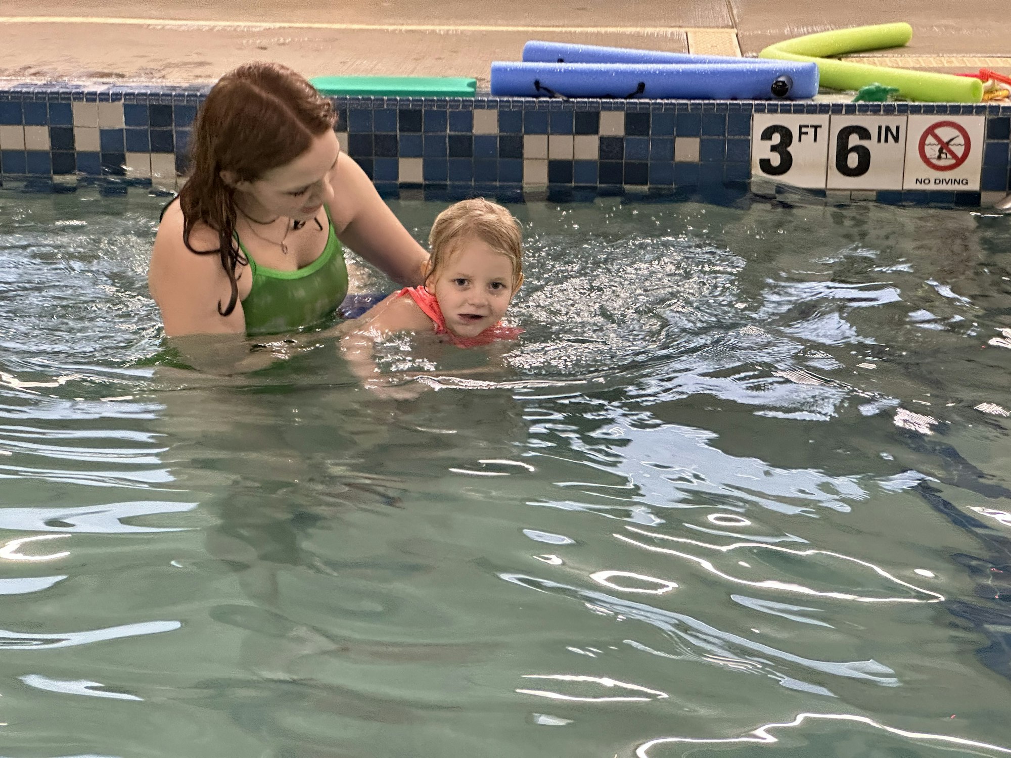 May contain: leisure activities, person, sport, swimming, water, water sports, clothing, swimwear, pool, swimming pool, summer, face, head, photography, portrait, lifejacket, vest, baby, accessories, jewelry, and necklace
