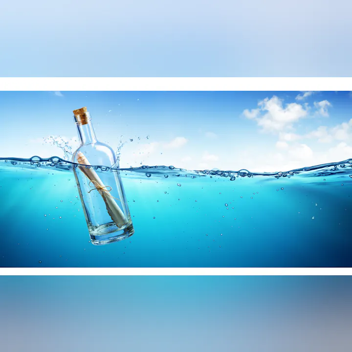 A sealed glass bottle with a message inside, floating in a body of water under a blue sky.