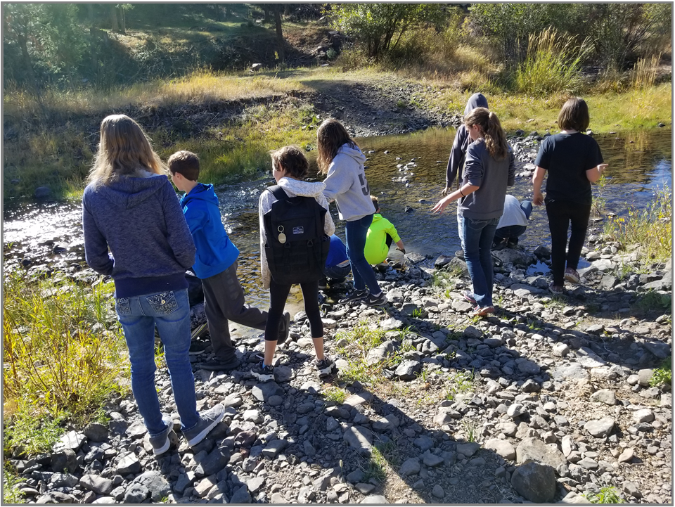 May contain: gravel, road, clothing, pants, person, walking, adventure, hiking, leisure activities, nature, outdoors, soil, jeans, coat, jacket, wilderness, rock, water, creek, and stream