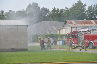 May contain: person, fire truck, transportation, truck, vehicle, helmet, clothing, and glove
