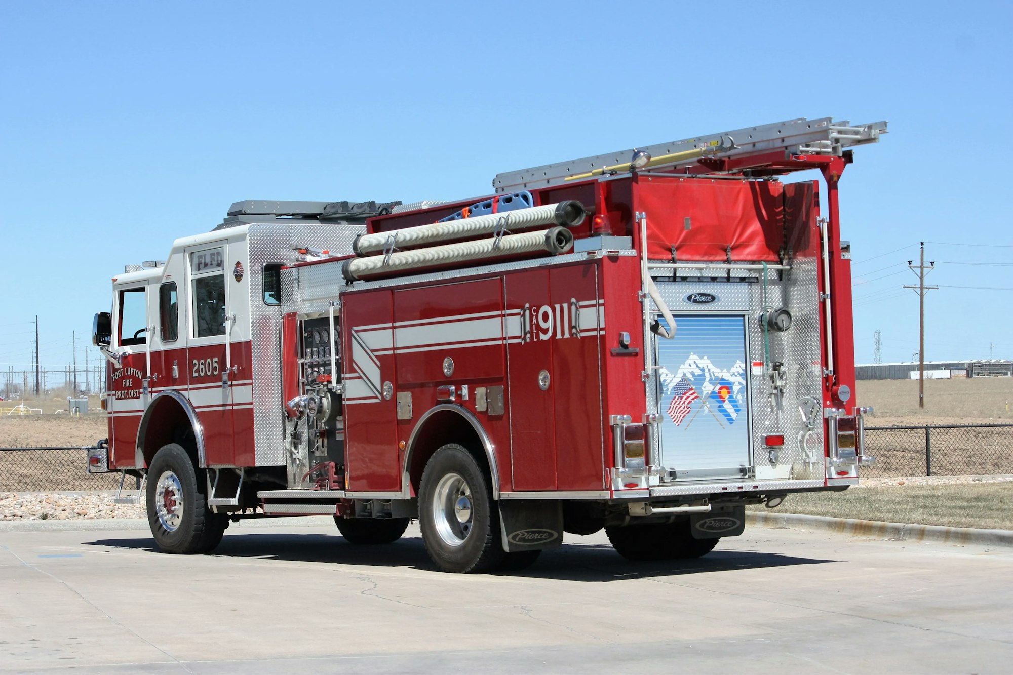 A red fire truck parked outside on a sunny day.