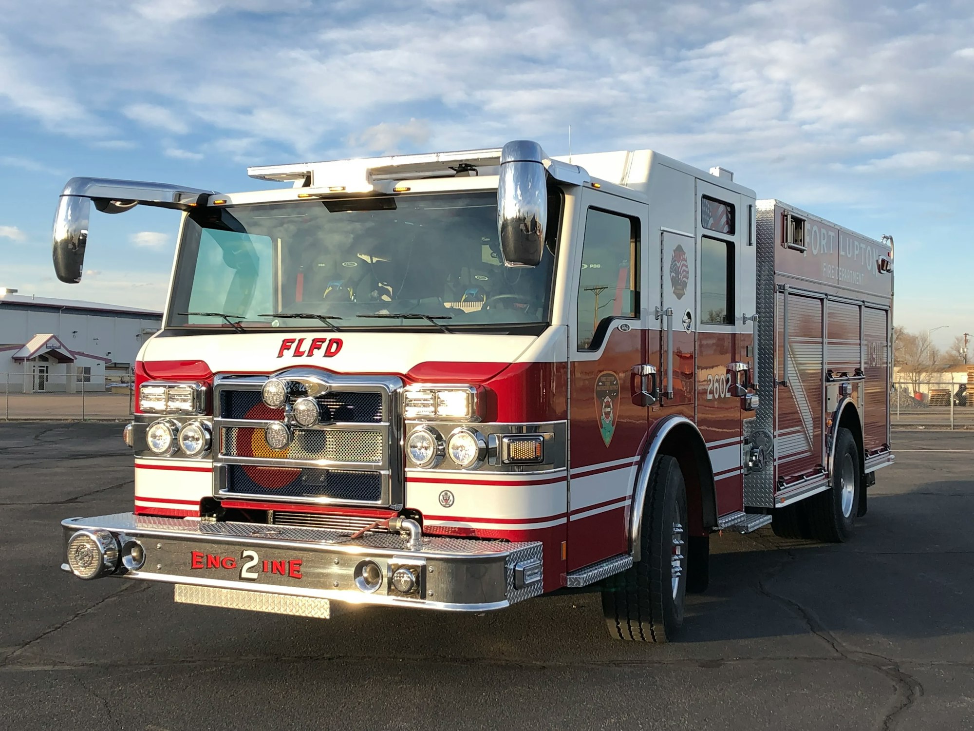 Red and white fire engine parked outdoors.