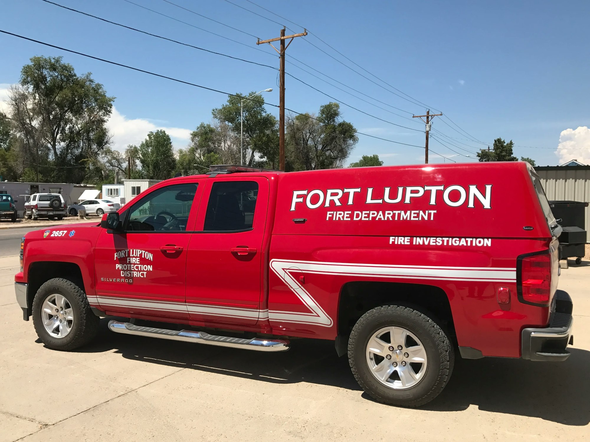 A red Fort Lupton Fire Department pickup truck with "Fire Investigation" on it.