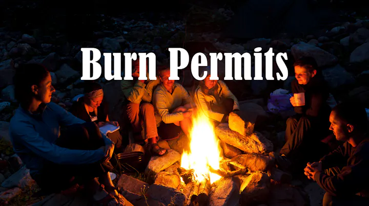 A group of people sits around a campfire at night, with the text "Burn Permits" prominently displayed above them.