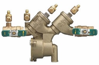 A brass backflow preventer valve with multiple shut-off handles and test cocks.