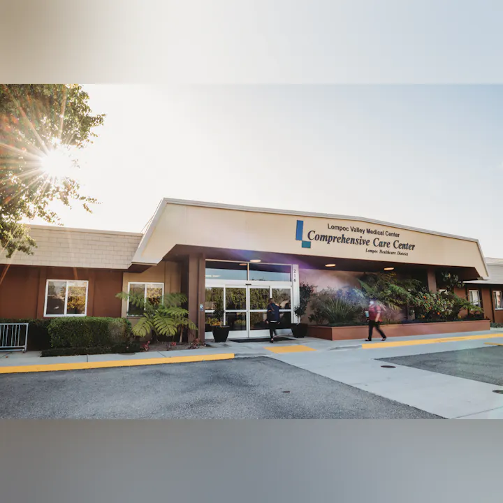 The image shows the Lompoc Valley Medical Center Comprehensive Care Center with people entering and exiting.