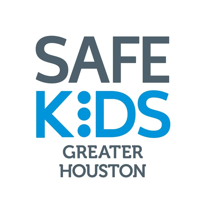 Logo for "SAFE KIDS GREATER HOUSTON" in grey and blue text.