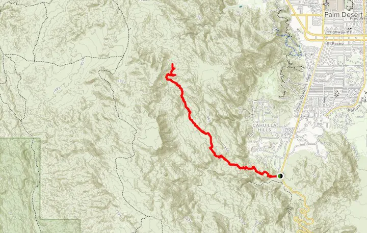 The image shows a map with a highlighted red trail running through mountainous terrain near Palm Desert, California.