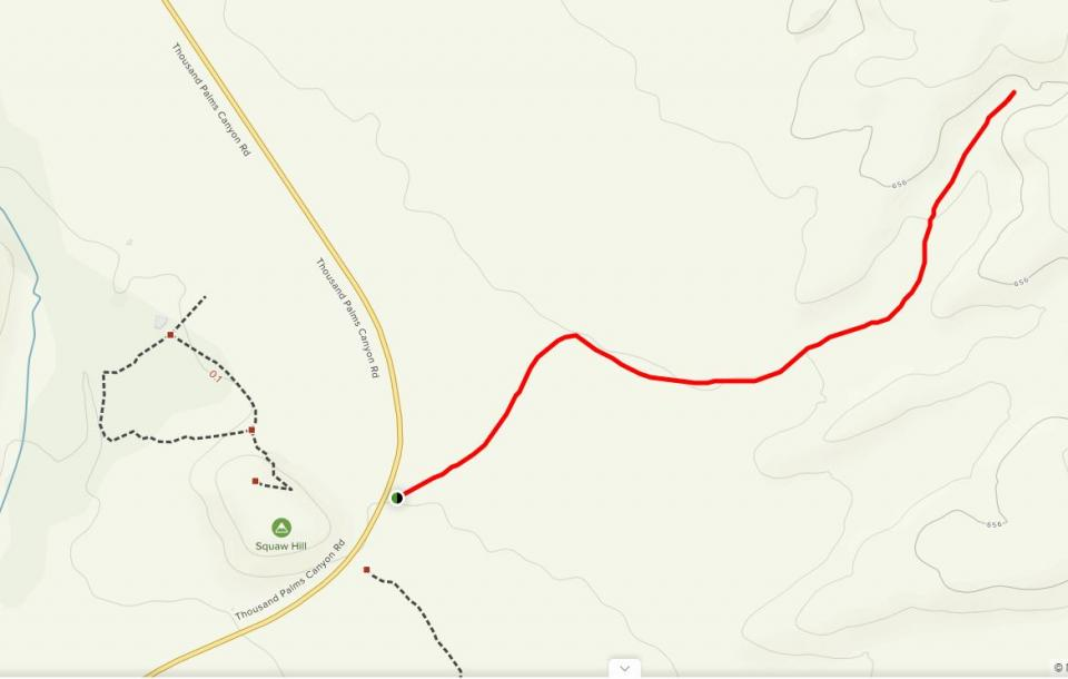The image depicts a mapped hiking trail in a mountainous area, marked in red, alongside roadways and terrain contours.