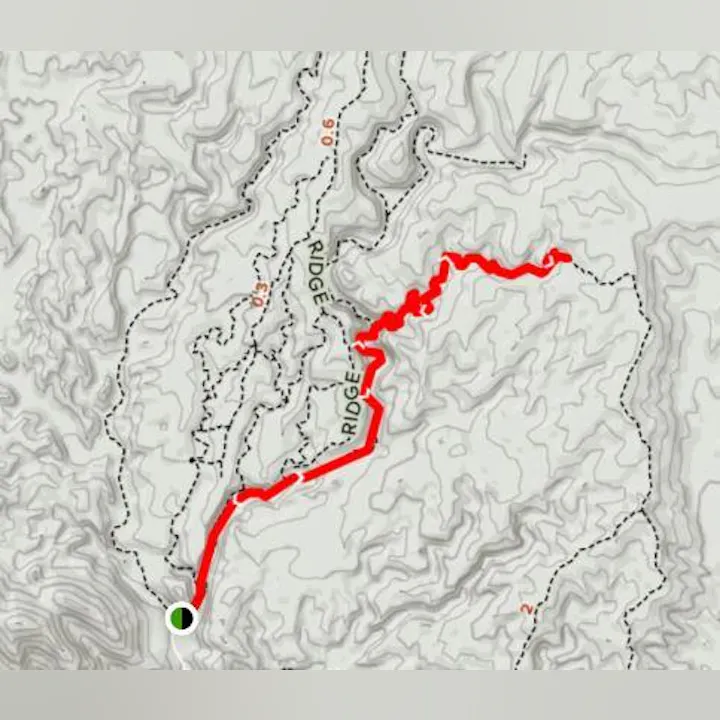 The image shows a topographic map highlighting a trail in red, indicating elevation changes and path direction.