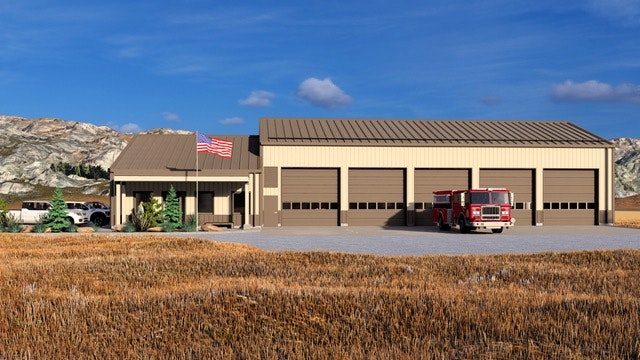 A fire station with several large garage doors, an American flag, a fire truck in front, and a mountainous landscape in the background.