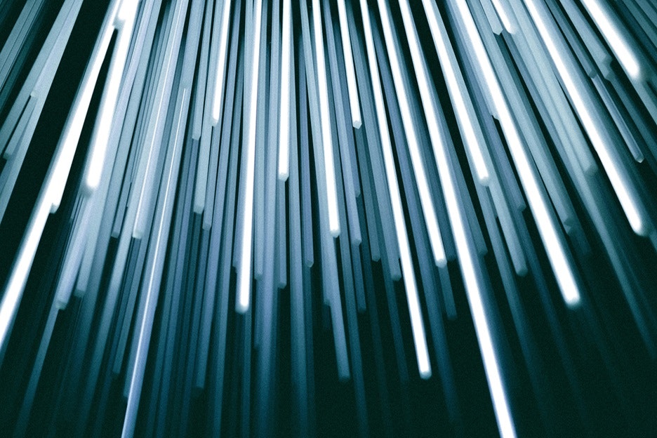 Abstract view of lights streaming through vertical slats with a cool blue tone. #AbstractArt #LightAndShadow