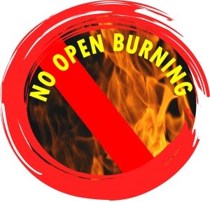 A circular sign with flames and a red slash, stating "No Open Burning."